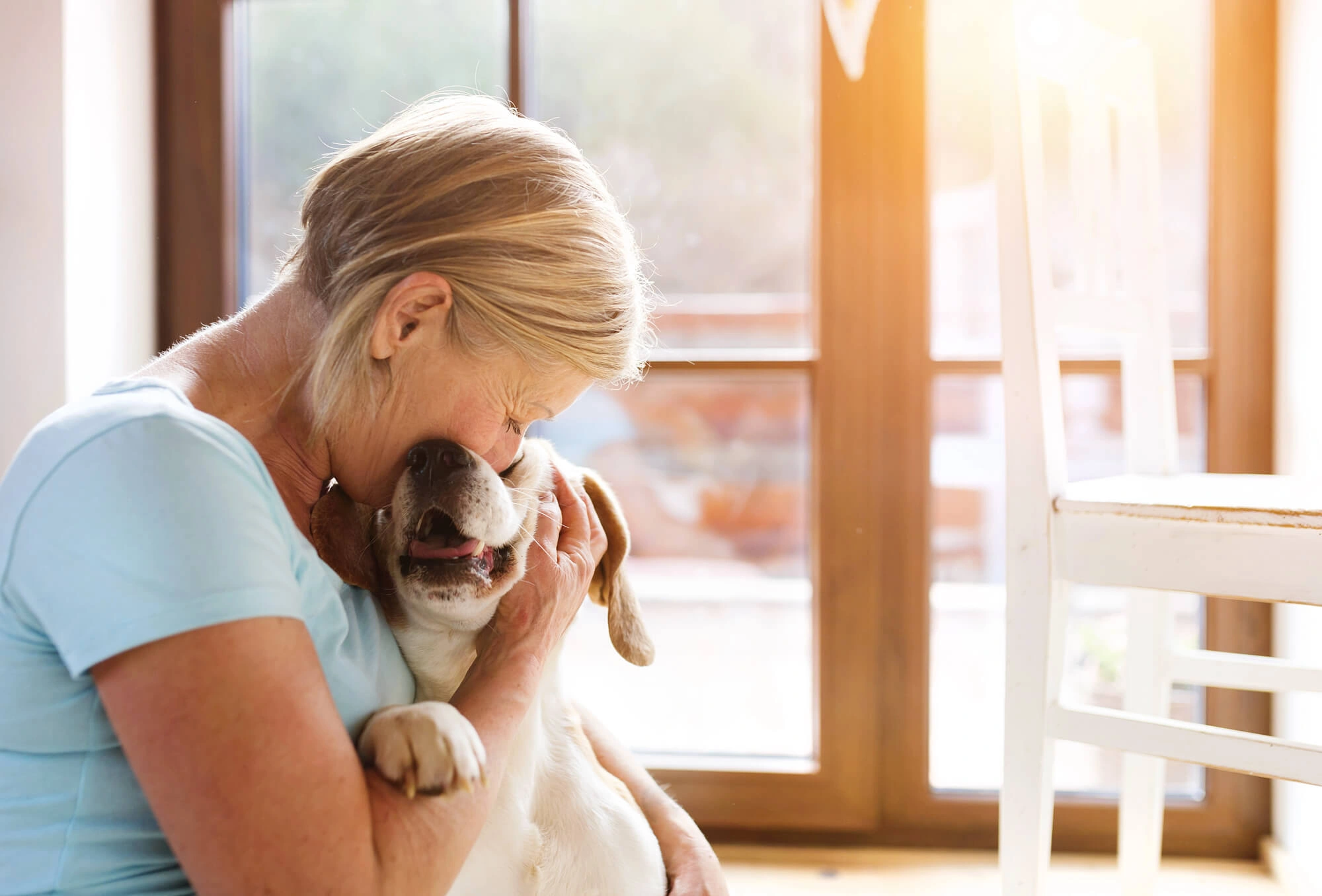 Owner hugging happy dog after visit to Great Plains Veterinary Clinic.